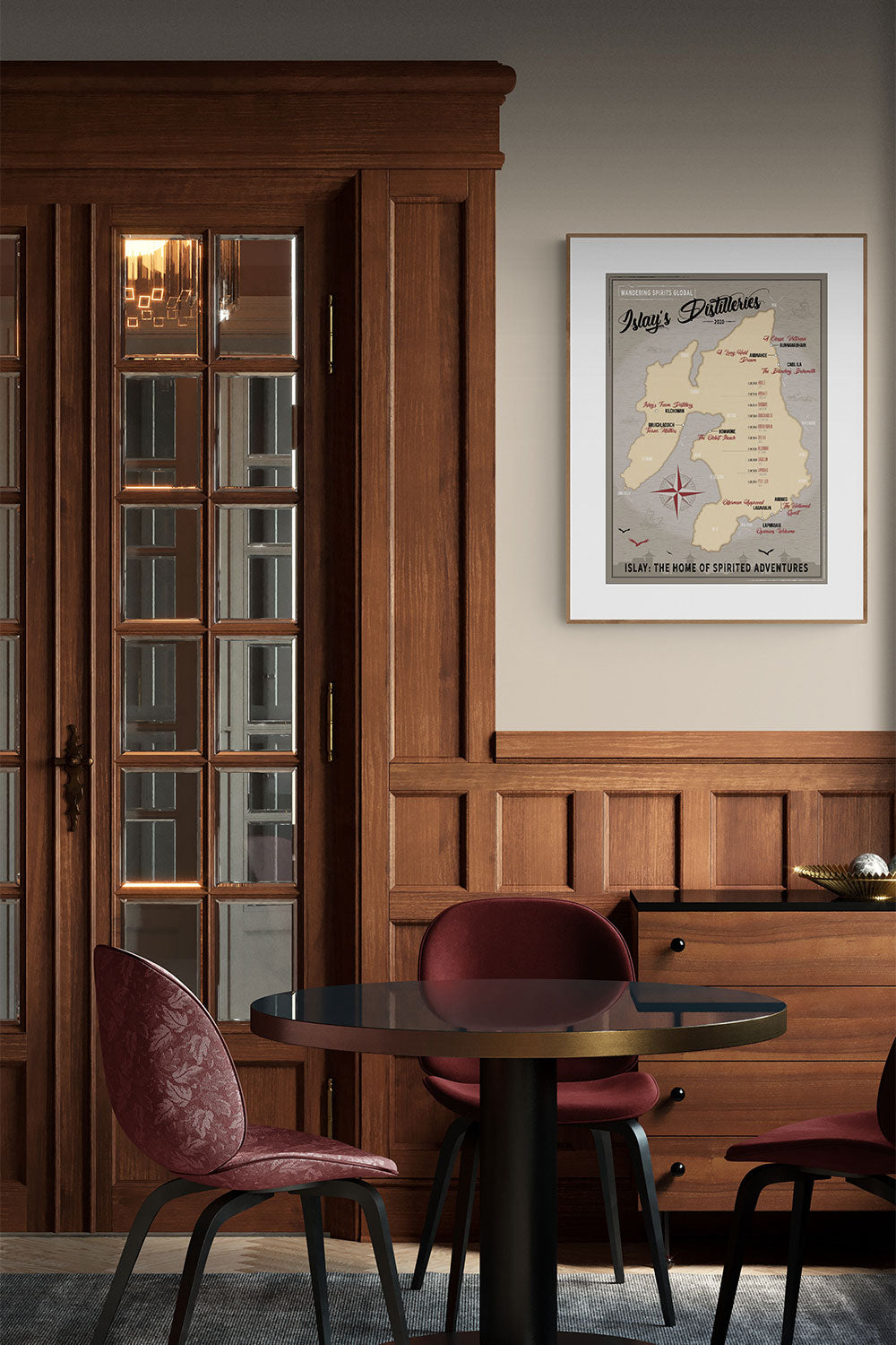 poster of islay distillery maps framed on wall in a timber lined bar with three chairs and a bar table in the foreground